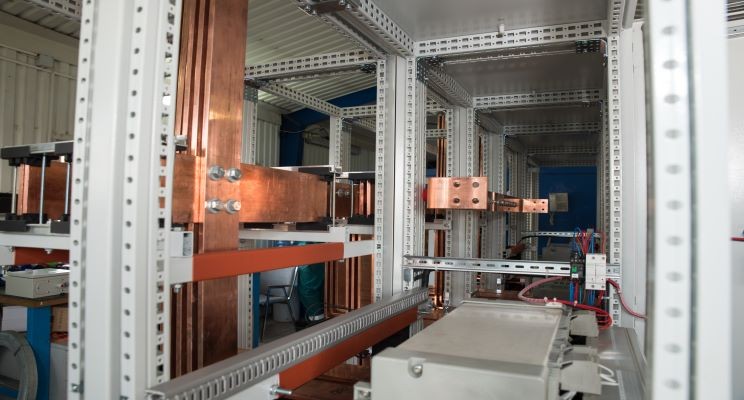 What is the role of a busbar in a panelboard?