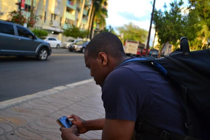 guy looking at his phone on the street