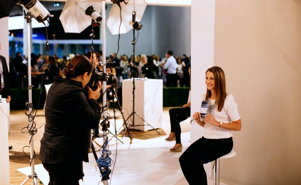 A woman getting a professional LinkedIn profile photo taken by a photographer at a LinkedIn event