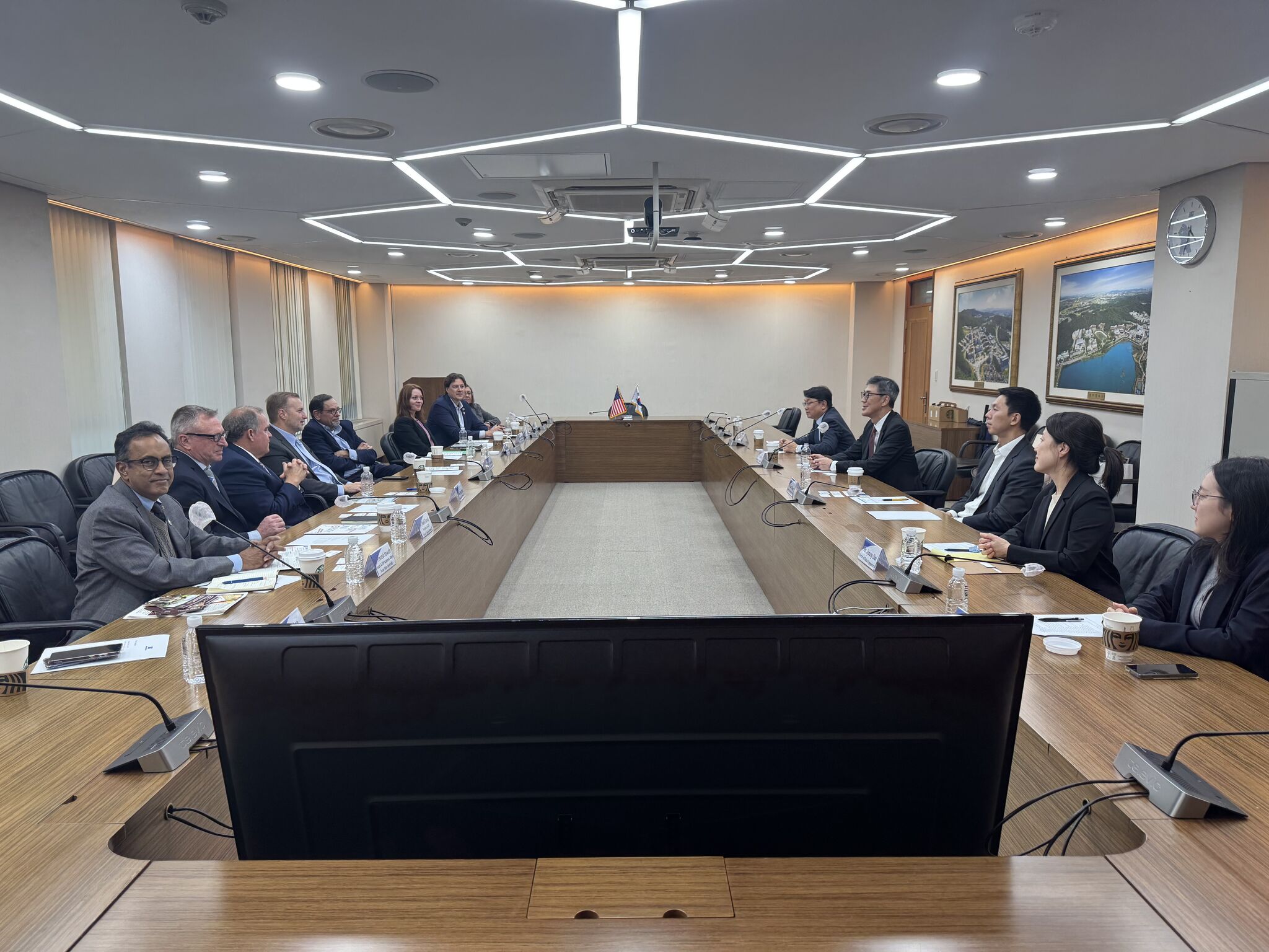 Representatives from central Texas and Dankook University are seated at a boardroom table for a meeting